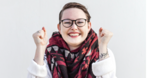A women with glasses who is very excited about WP Engine Hosting