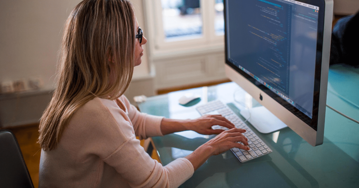 woman working at her computer, removing the multiple meta description tags error