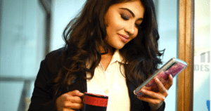 business woman with brown hair reviewing elementor features on her smart phone
